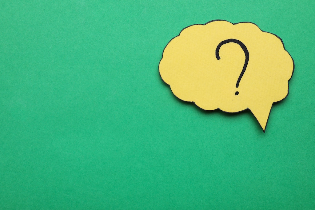 Question mark on yellow speech bubble with green background. 