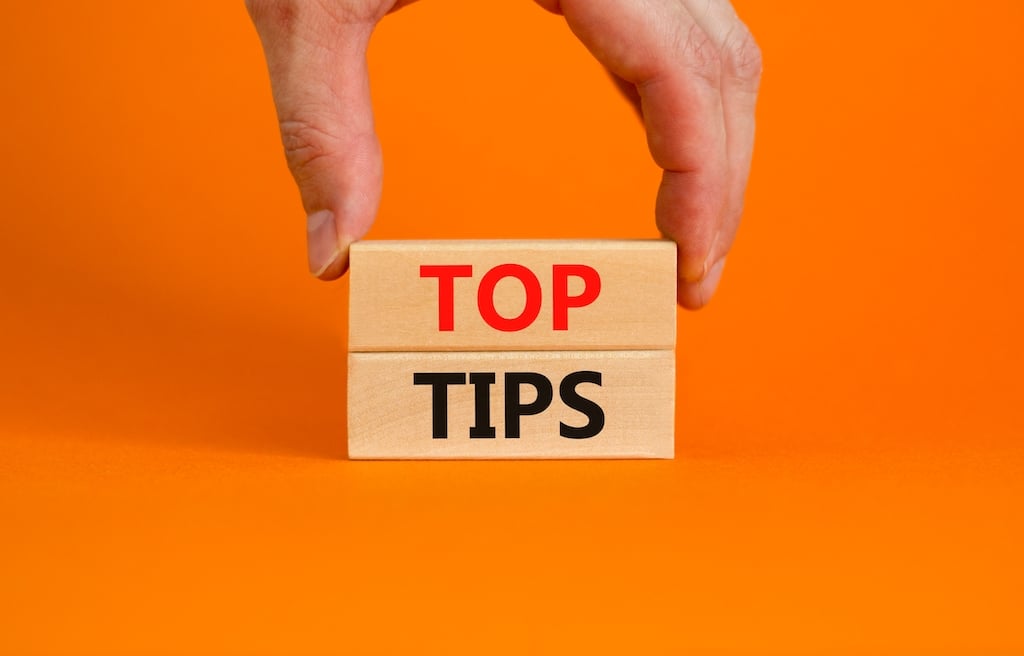 Two wooden blocks with 'Top Tips' written on it. Orange background. | Water Backflow Testing