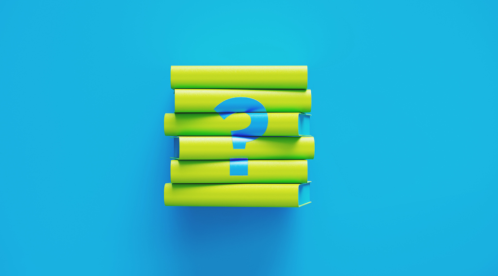 Green book stack with blue question mark sitting on blue background. Horizontal composition with copy space. Air Filters and Purifiers 
