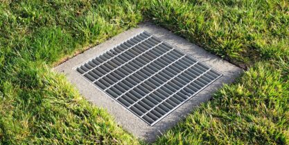 Catch basin surrounded by grass. | catch basin cleaning