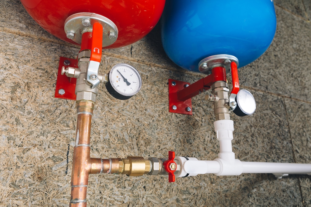 Red and blue expansion tanks with pressure gauge. 