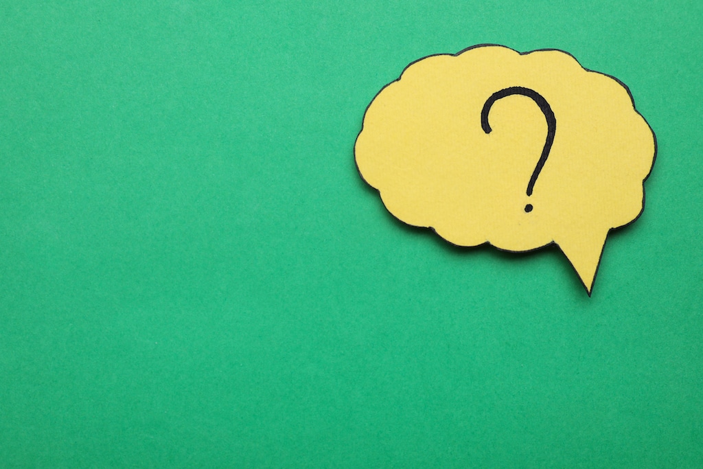 Question mark on yellow speech bubble with green background.