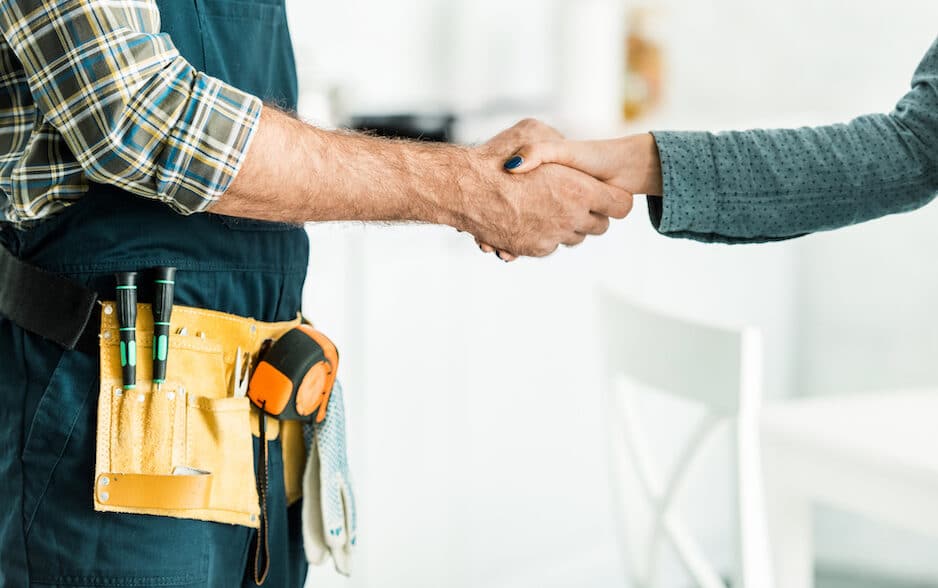 Plumber shaking hands with homeowner. | Madisonville's Premier Plumbing Services
