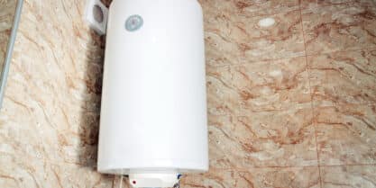 Tankless water heater inside of residential bathroom. | Tankless Water Heater Service Valves